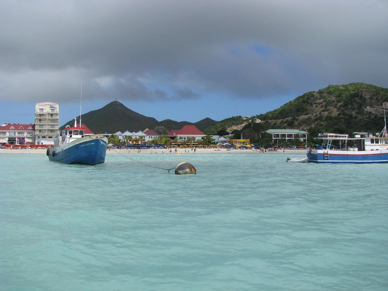 Fishing boats anchored in the turquoise bay of St. Maarten